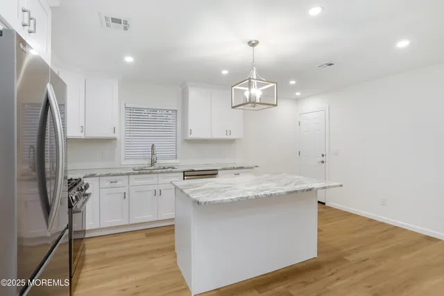 a kitchen that has a sink stainless steel appliances a counter space and cabinets