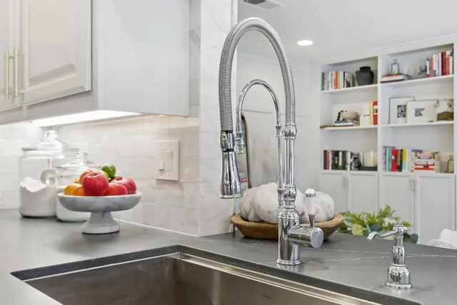 a kitchen with stove a sink and cabinets