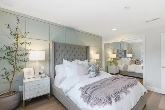 a bedroom with a bed and a flat screen tv