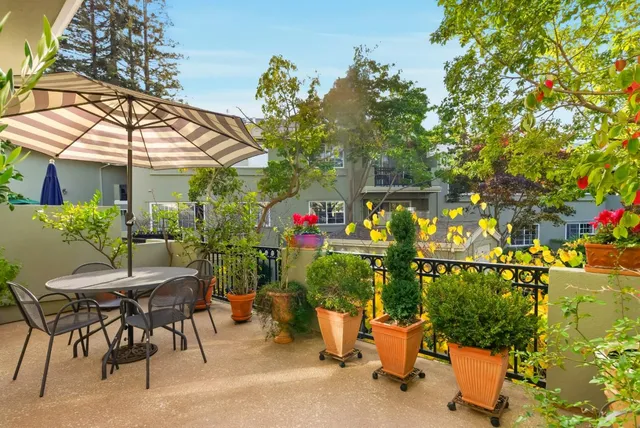 a view of a patio with a table and chairs