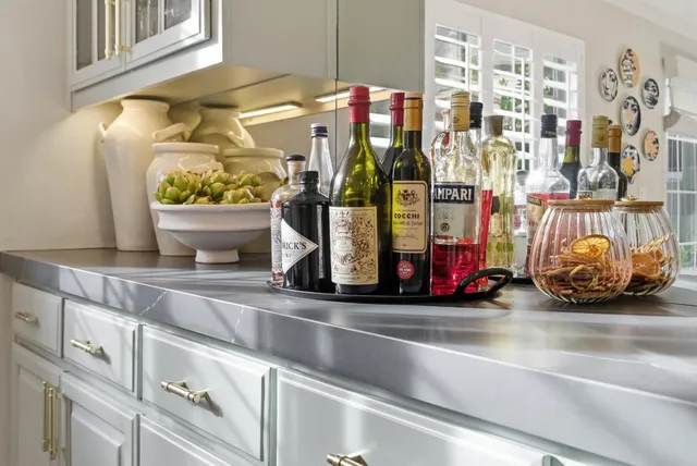 a kitchen with stainless steel appliances granite countertop a stove and cabinets