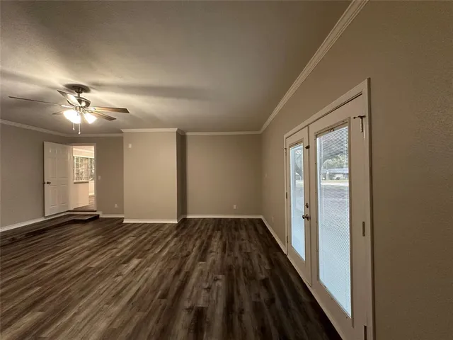 wooden floor in an empty room with a window