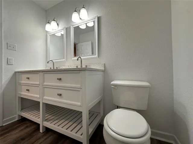 a bathroom with a toilet a sink and a mirror
