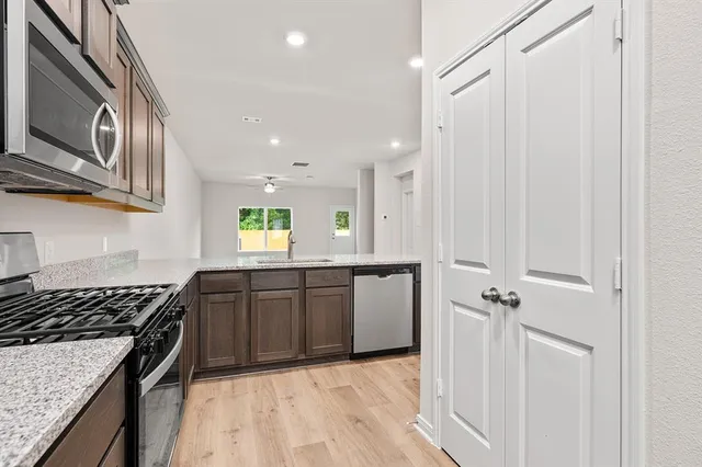a kitchen with a stove a sink and a refrigerator
