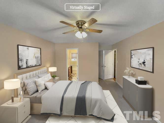 5225 Knightsbridge Way Raleigh, NC 27604 - Photo 3 of 21 a bedroom with a bed and a chandelier