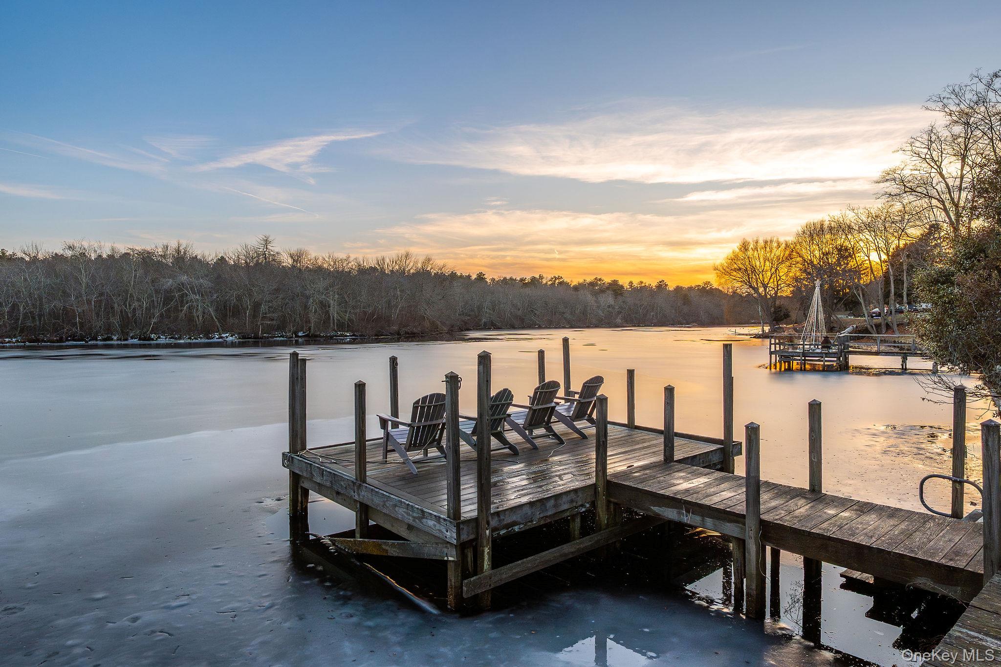 Dock with a water view and a forest view