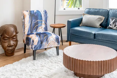 a living room with furniture a window and a potted plant