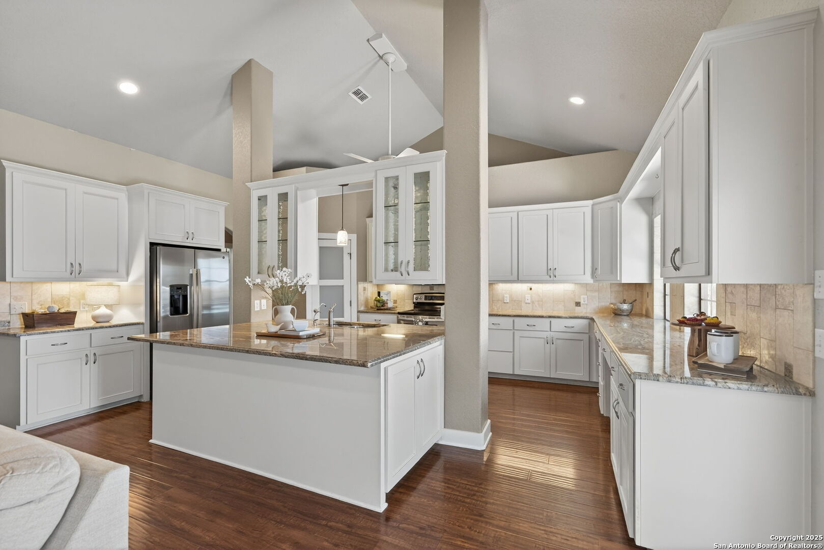 905 Cypress Pass Road Spring Branch, TX 78070 - Photo 11 of 42 a kitchen with a sink stove cabinets and wooden floor