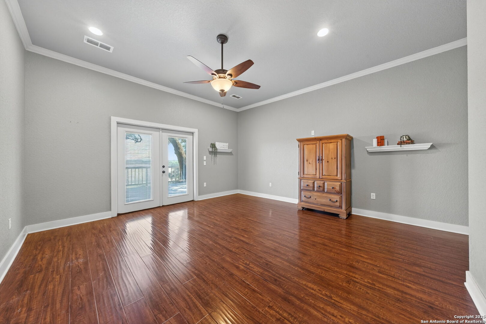 905 Cypress Pass Road Spring Branch, TX 78070 - Photo 19 of 42 a view of an empty room with window and wooden floor