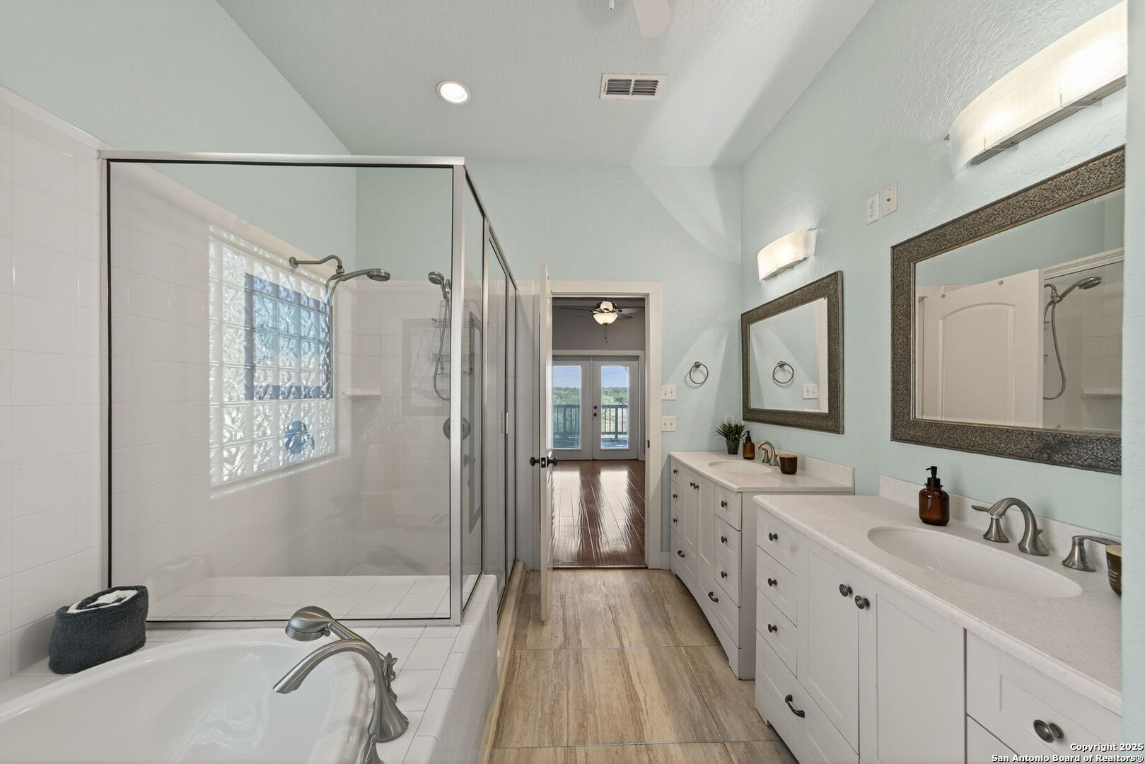 905 Cypress Pass Road Spring Branch, TX 78070 - Photo 22 of 42 a bathroom with a double vanity sink a mirror and a shower