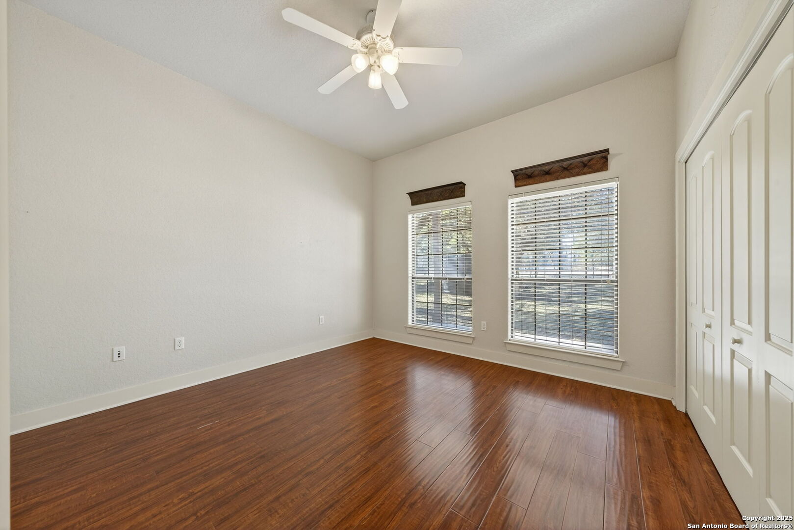905 Cypress Pass Road Spring Branch, TX 78070 - Photo 25 of 42 an empty room with wooden floor and windows