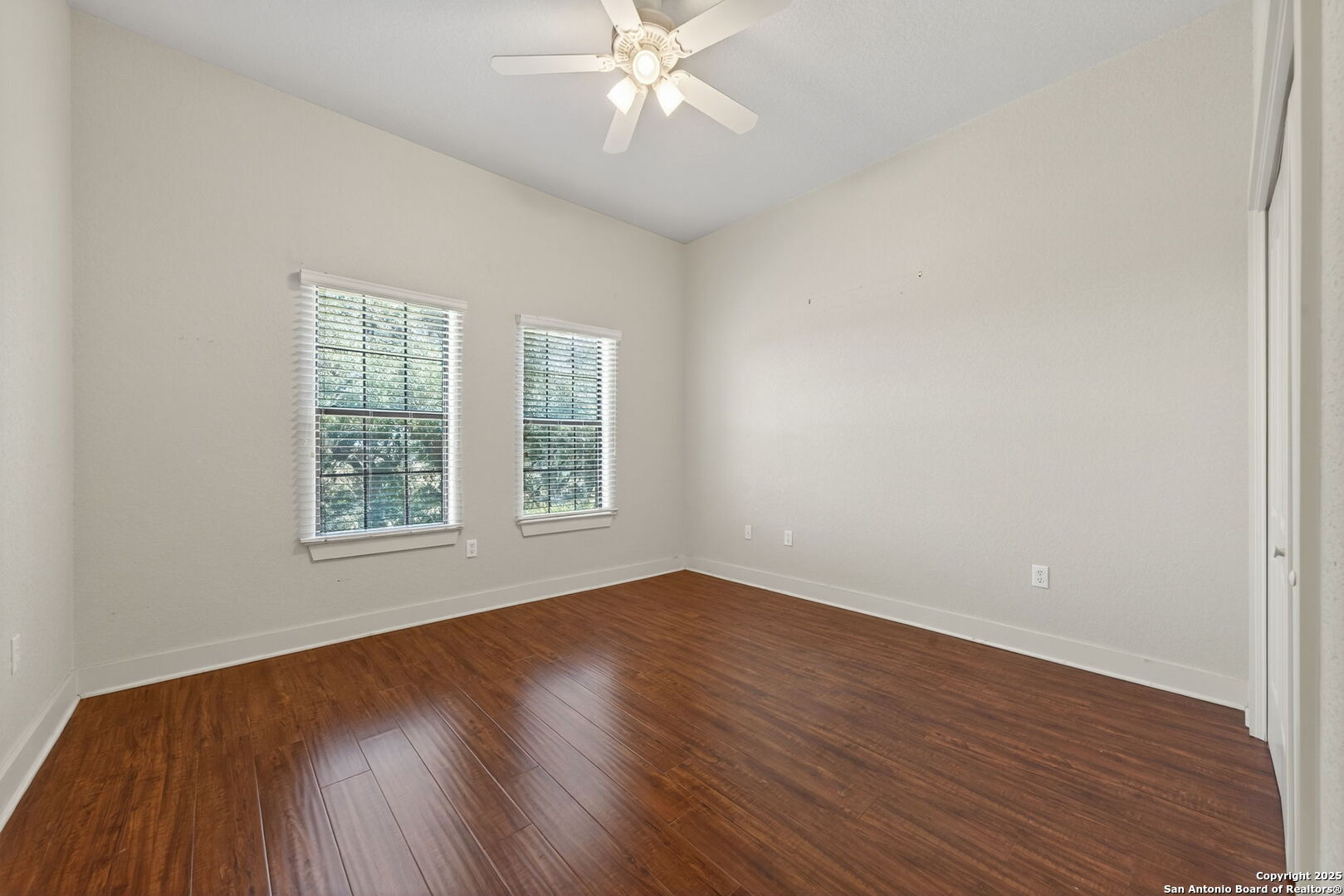 905 Cypress Pass Road Spring Branch, TX 78070 - Photo 28 of 42 an empty room with wooden floor windows and fan