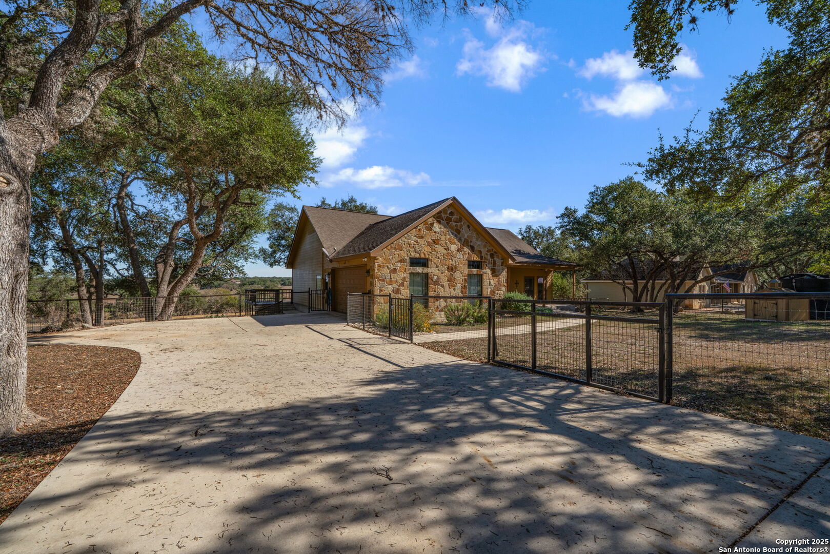 905 Cypress Pass Road Spring Branch, TX 78070 - Photo 4 of 42 a street view with wooden fence and a tree
