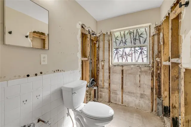 a bathroom with a toilet sink and shower