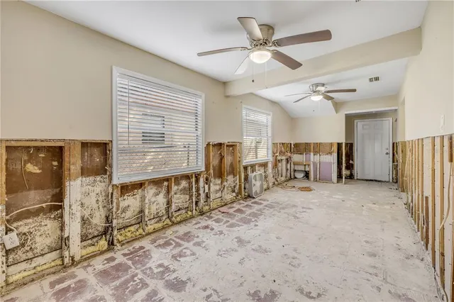 a view of a livingroom with wooden floor and a ceiling fan