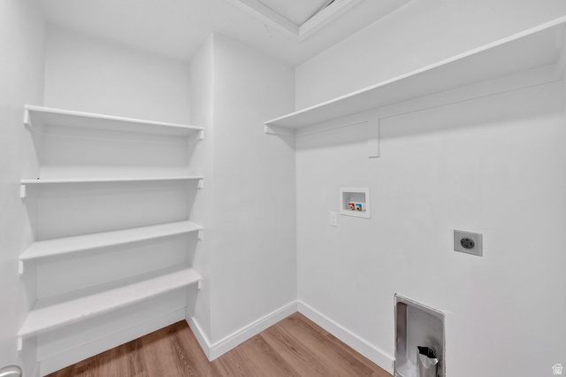 295 Spruce Way Santaquin, UT 84655 - Photo 21 of 32 Utility room featuring a long upper shelf, four corner shelves, wood-finish flooring, and white baseboards