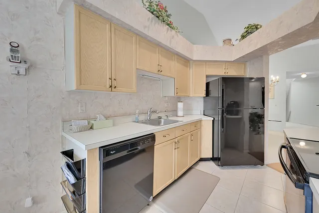 a kitchen with a sink stainless steel appliances and cabinets
