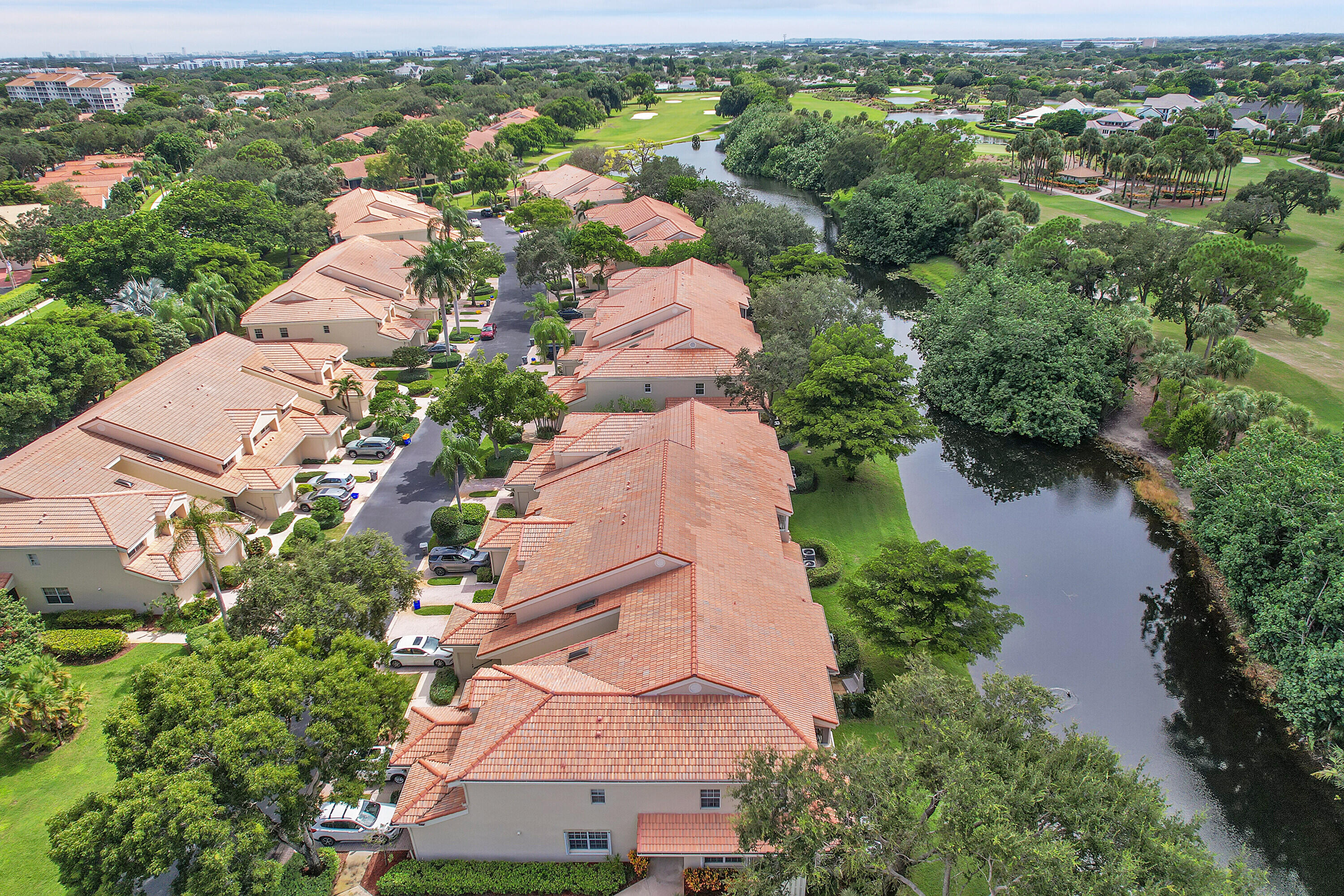 17270 Boca Club Boulevard, Unit 1702 Boca Raton, FL 33487 - Photo 34 of 41 an aerial view of a house with a yard and lake view