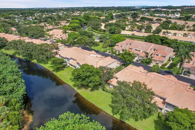 an aerial view of residential houses with outdoor space and river