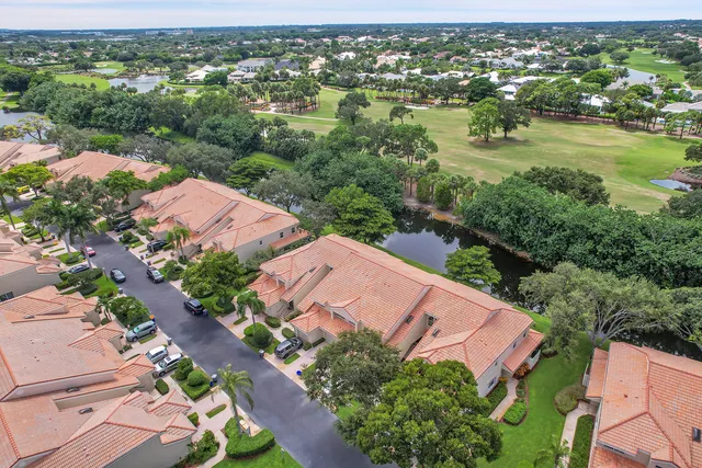 an aerial view of residential houses with outdoor space and river