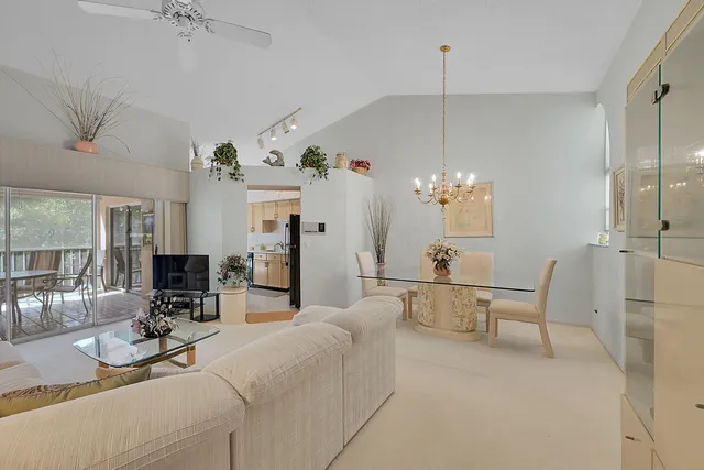 a living room with furniture a chandelier and a chandelier