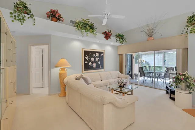 a living room with furniture and flowers