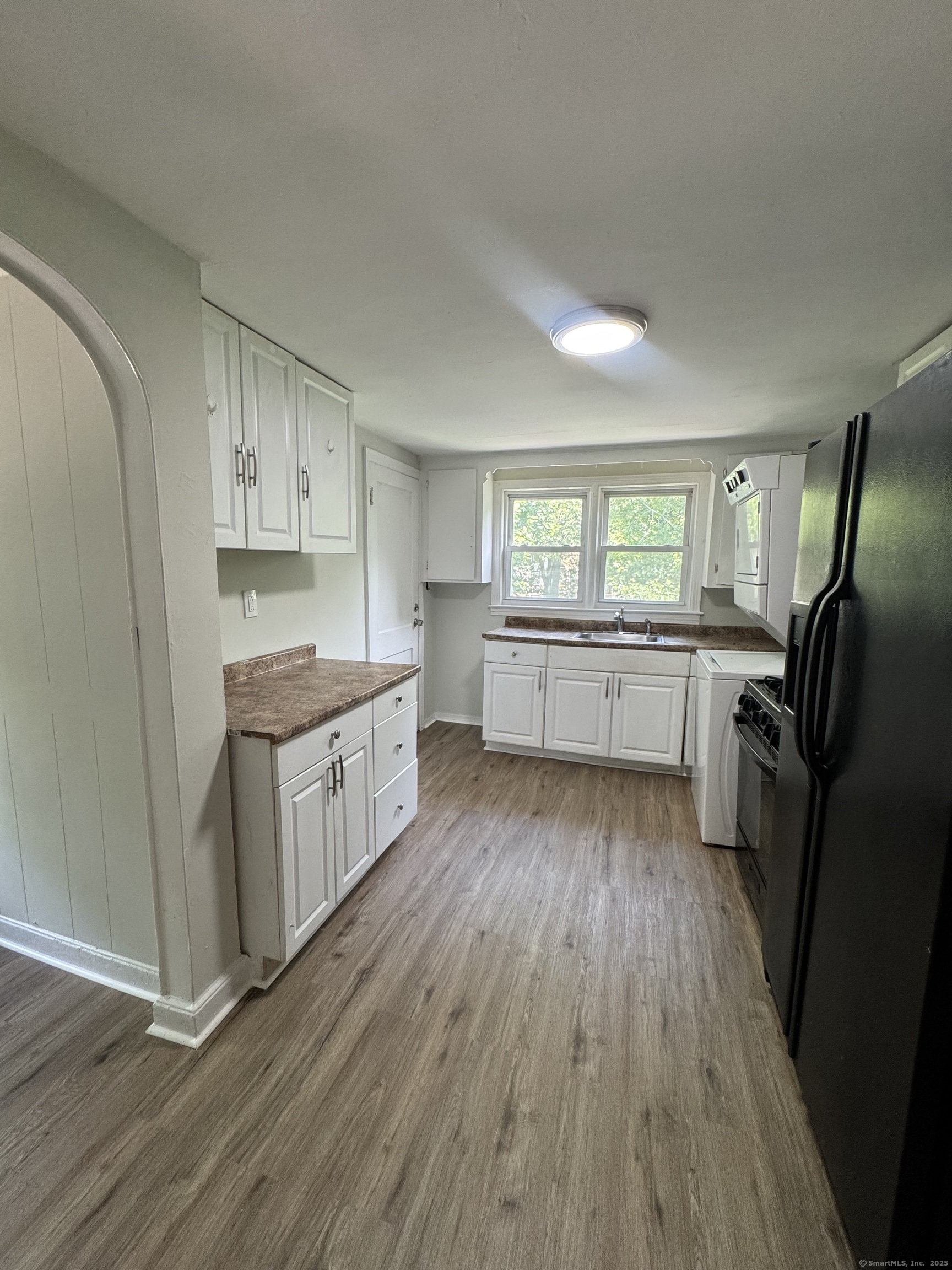 35 Goodyear Street, Unit 2 New Haven, CT 06511 - Photo 3 of 10 a kitchen with stainless steel appliances granite countertop a refrigerator a sink dishwasher a stove and white countertops with wooden floor