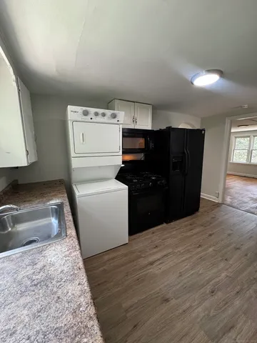 a kitchen with a refrigerator and a stove