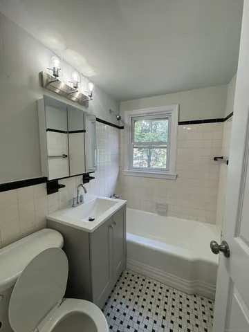 a bathroom with a toilet a sink and bathtub