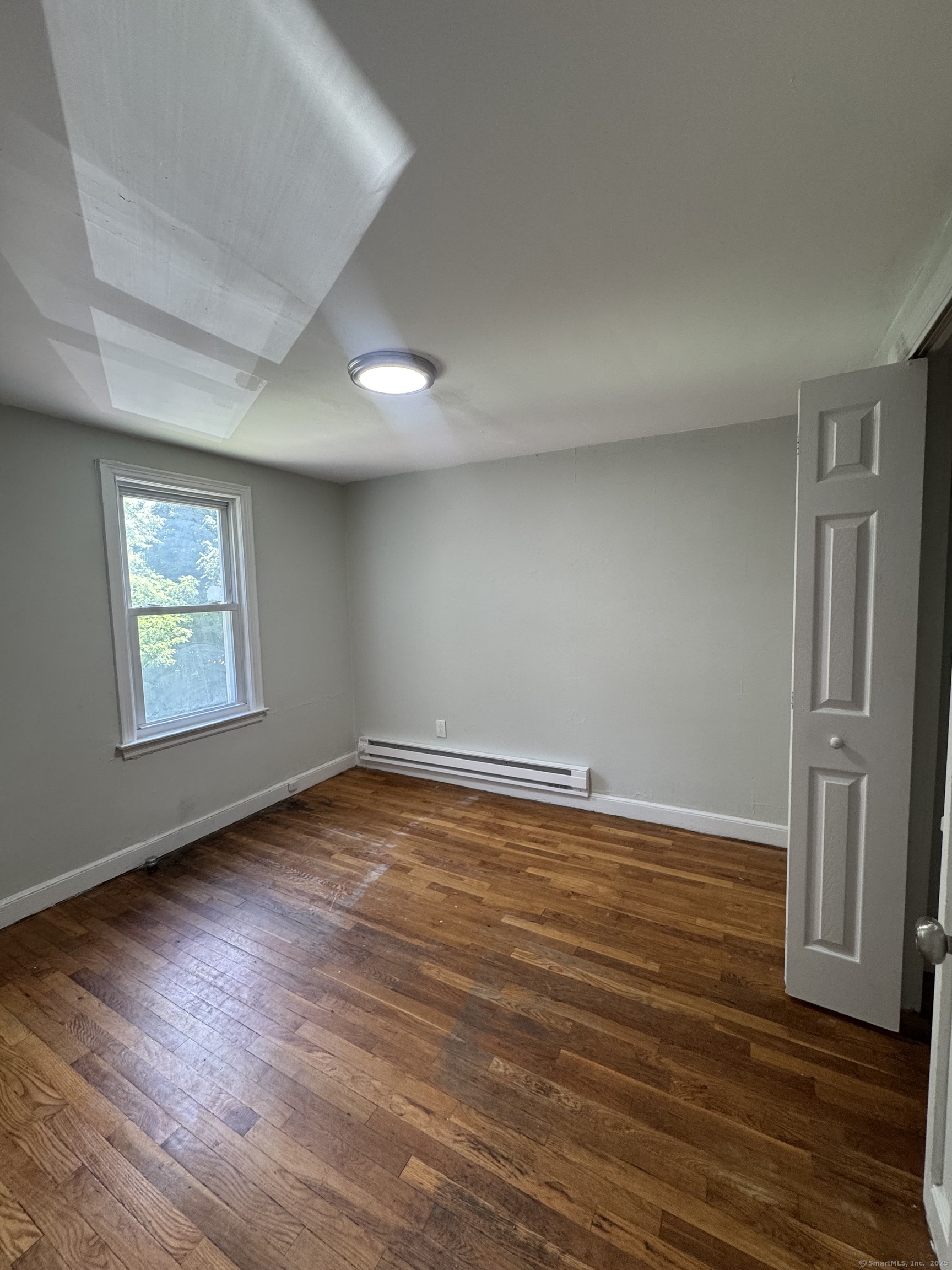 35 Goodyear Street, Unit 2 New Haven, CT 06511 - Photo 8 of 10 an empty room with wooden floor and windows