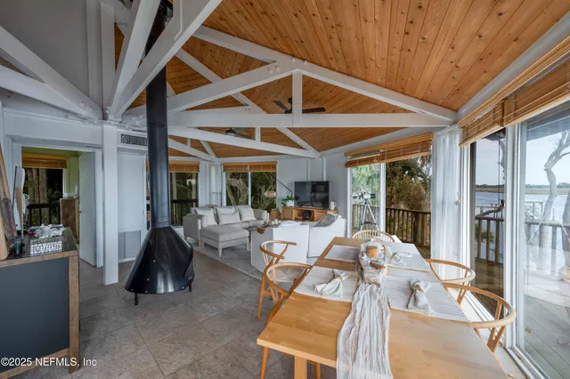 a view of a livingroom with furniture wooden floor and windows