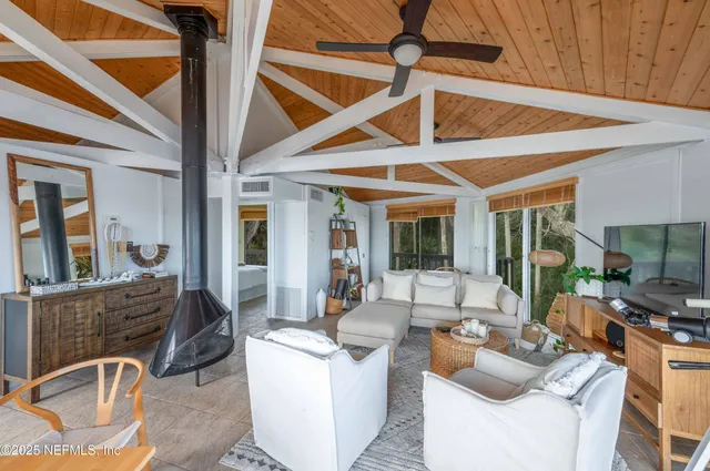 a living room with fireplace furniture and a floor to ceiling window