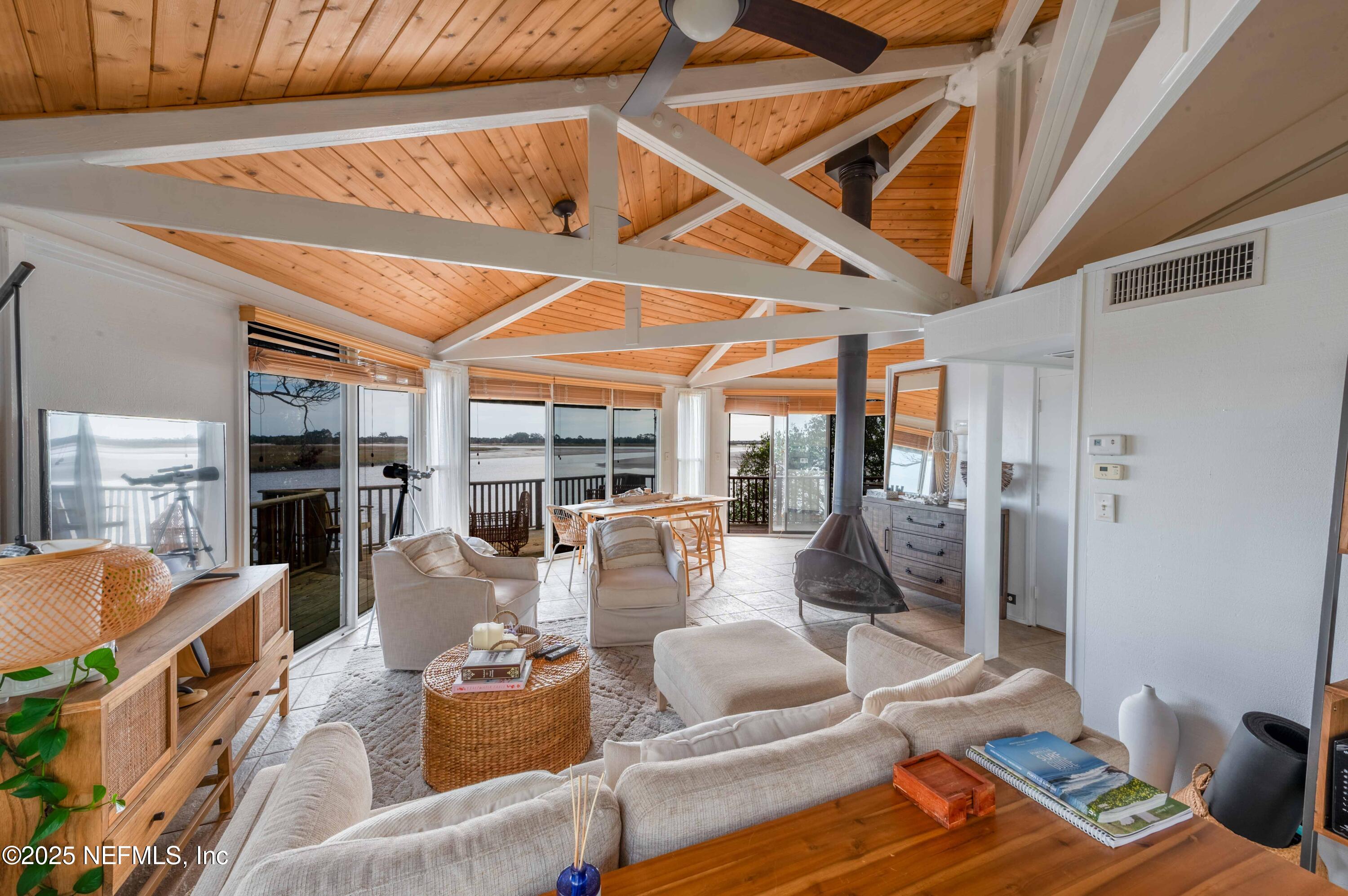 11255 Fort George Road Jacksonville, FL 32226 - Photo 31 of 38 a living room with fireplace furniture and a floor to ceiling window