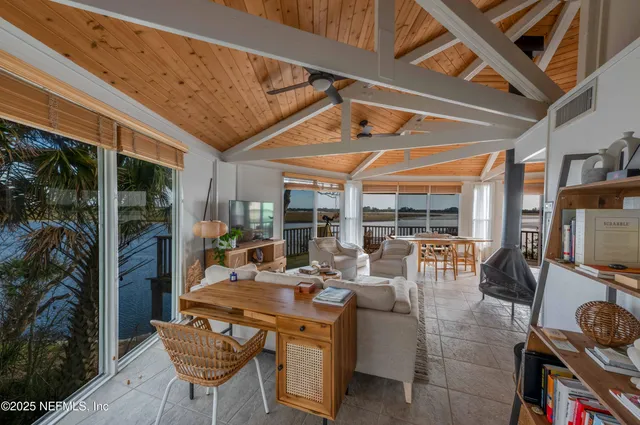 a bedroom with furniture and a large window
