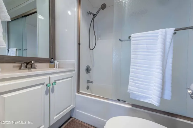 a bedroom with a large bed and a large window