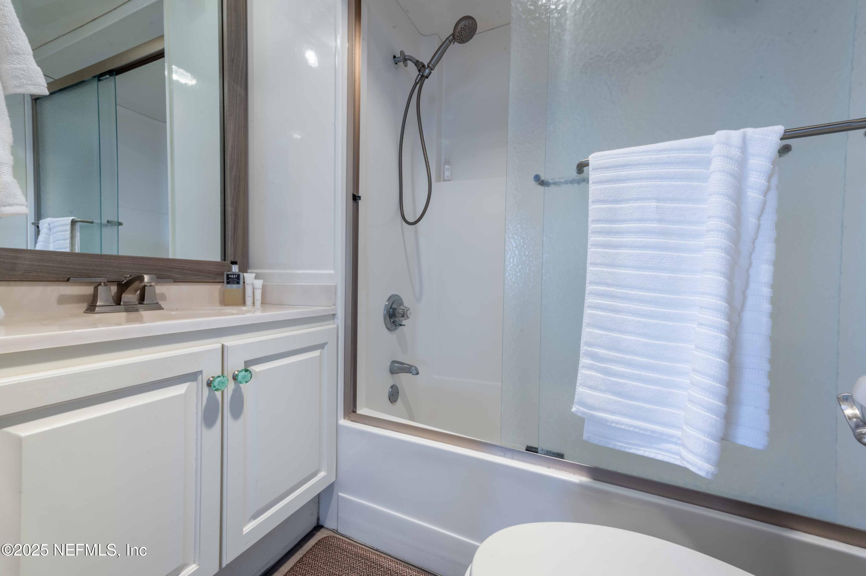 11255 Fort George Road Jacksonville, FL 32226 - Photo 33 of 38 a bathroom with a granite countertop sink mirror and a bathtub