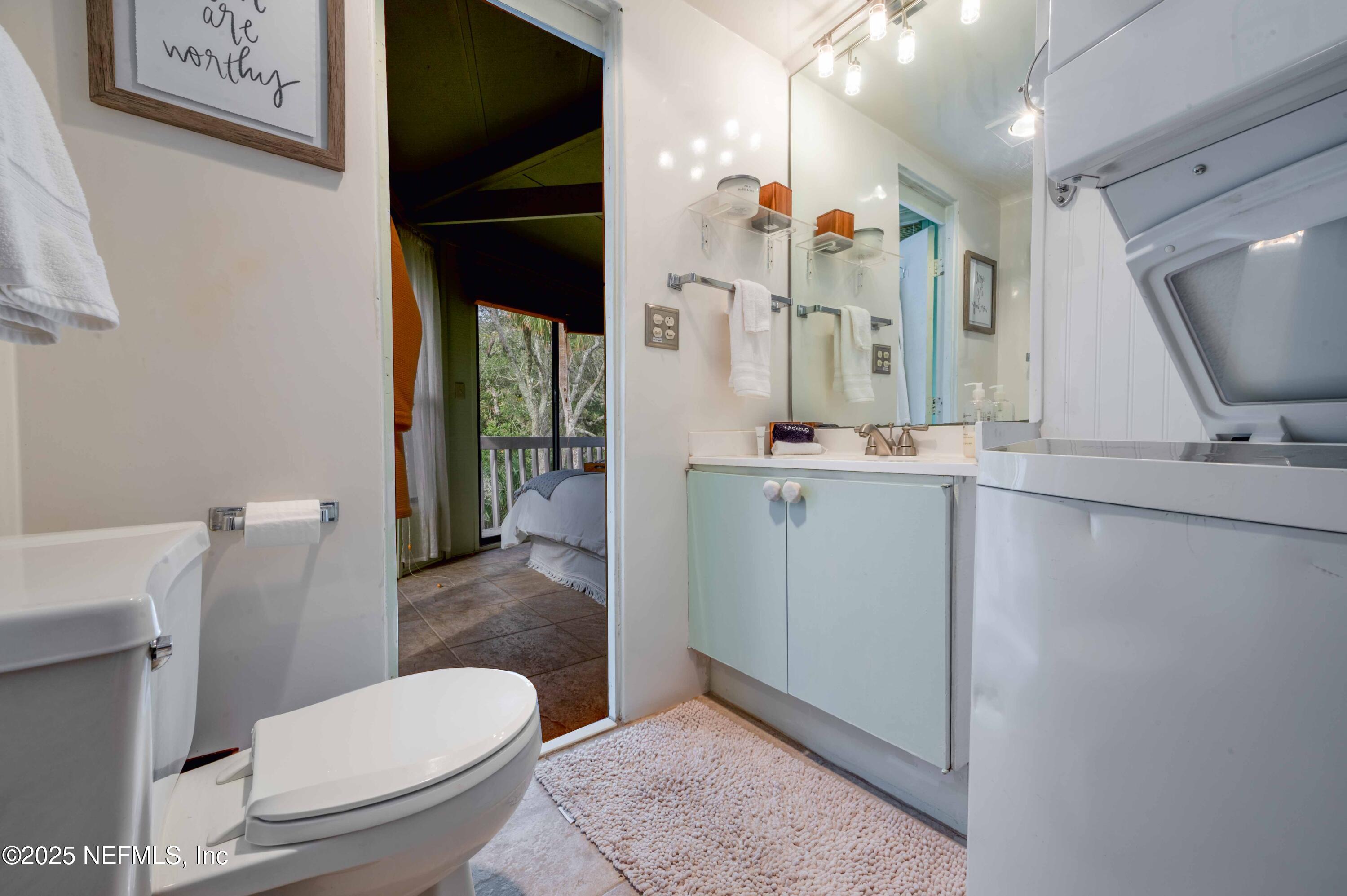 11255 Fort George Road Jacksonville, FL 32226 - Photo 38 of 38 a bathroom with a toilet sink and mirror