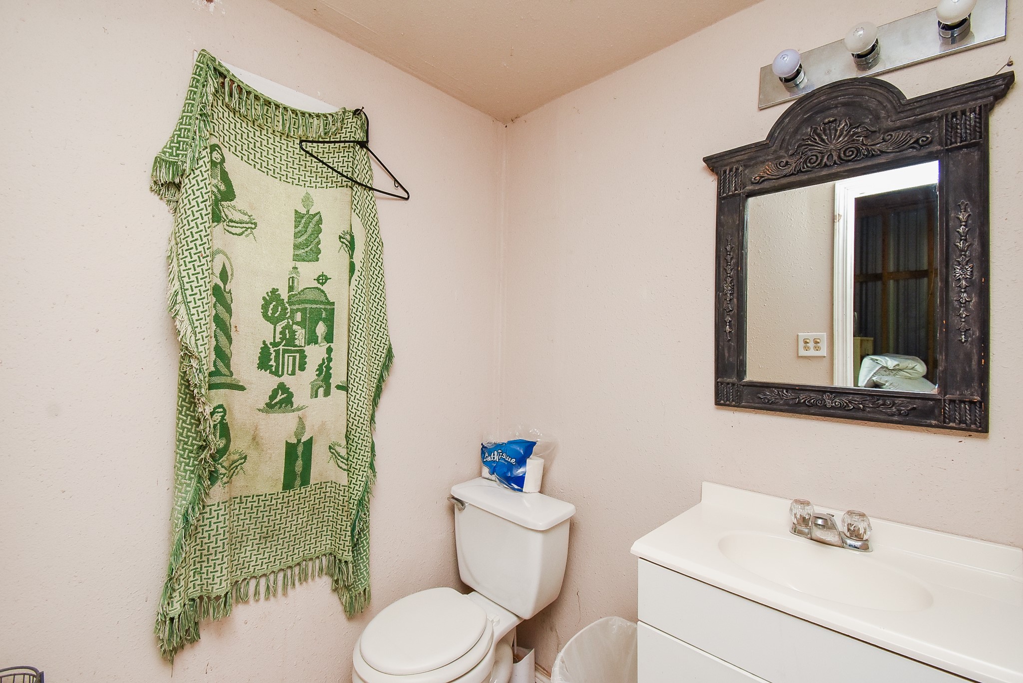 39551 Donigan Road Brookshire, TX 77423 - Photo 30 of 37 a bathroom with a toilet sink and mirror