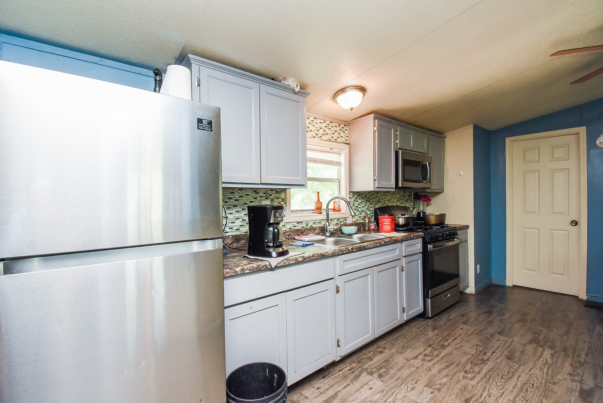 39551 Donigan Road Brookshire, TX 77423 - Photo 35 of 37 a kitchen with stainless steel appliances a refrigerator sink and microwave