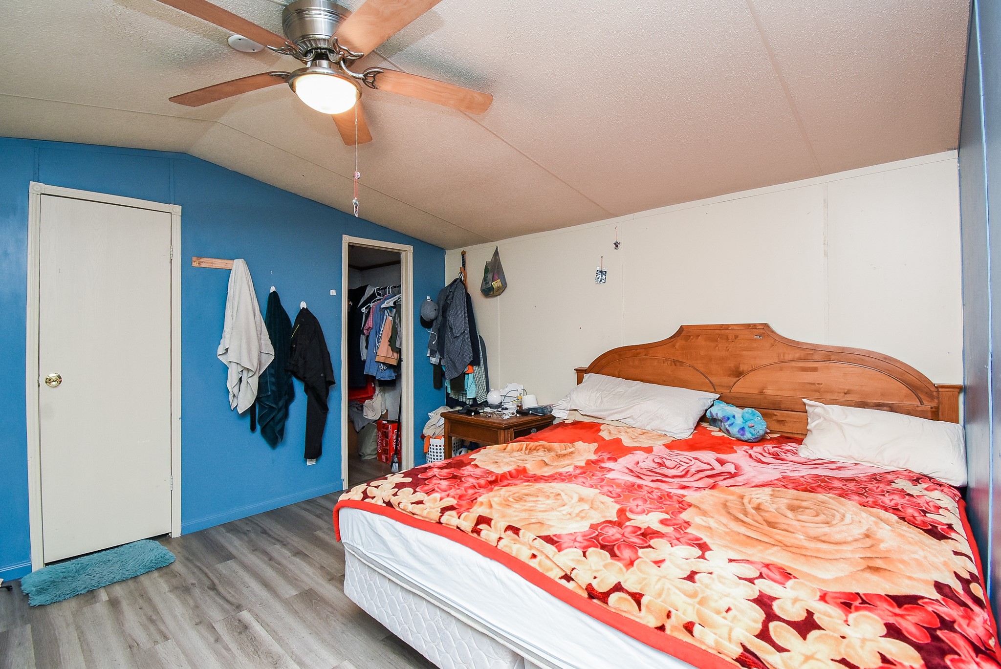 39551 Donigan Road Brookshire, TX 77423 - Photo 37 of 37 a bedroom with a bed and a chandelier