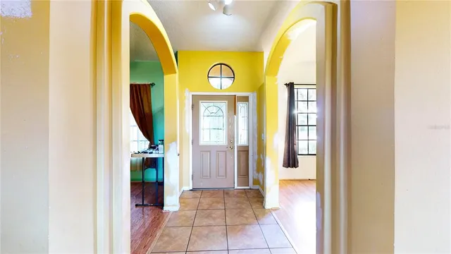 a spacious bedroom with a bed and wooden floor