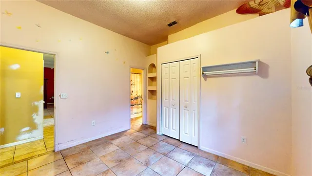 a bedroom with bed and a chandelier