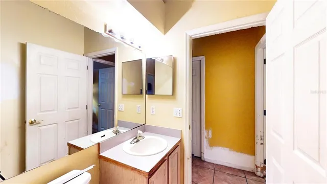 a view of bathroom with mirror and window