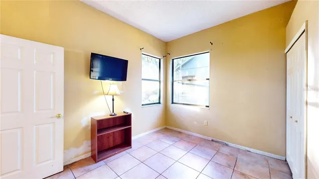 a large white kitchen with stainless steel appliances and cabinets
