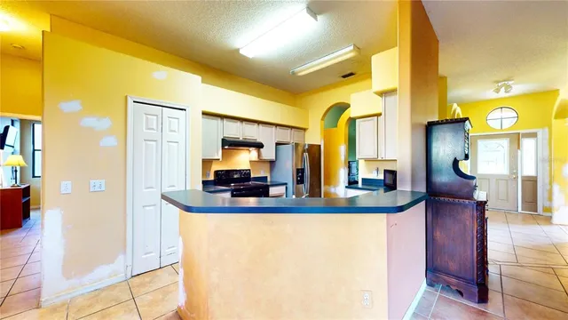a view of a house with a big yard and large trees