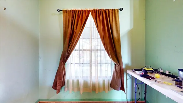 a view of a livingroom with furniture and a window