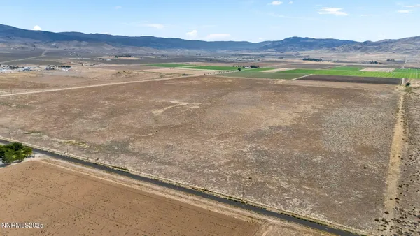 a view of a field with a mountain in the background