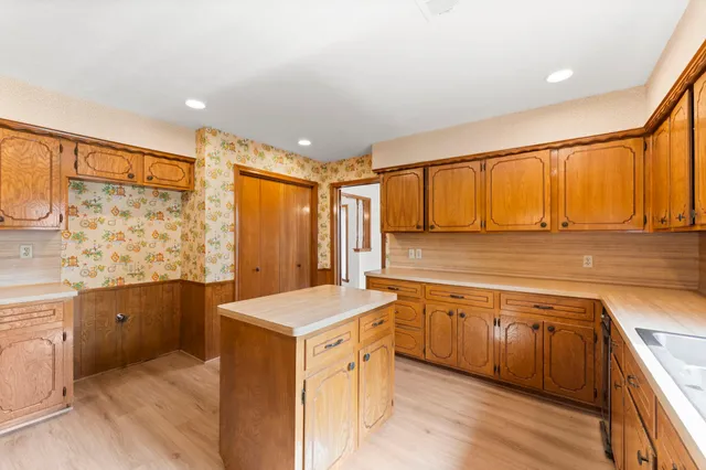 a spacious bathroom with a granite countertop sink and a bathtub