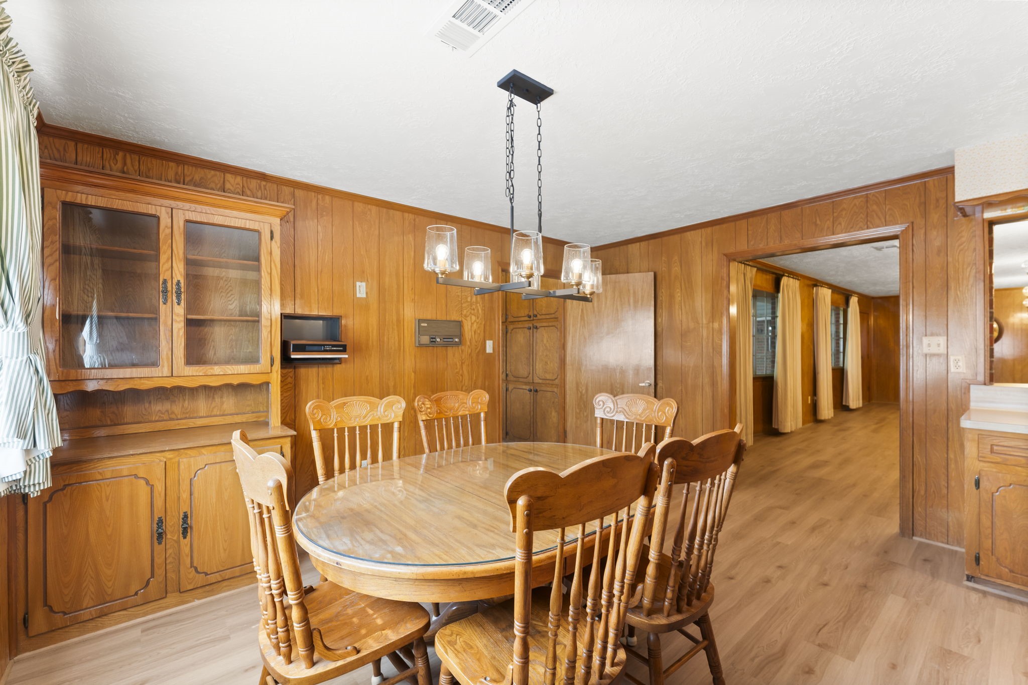 2810 Lilac Street Pasadena, TX 77503 - Photo 13 of 38 a dining room with furniture a chandelier and wooden floor