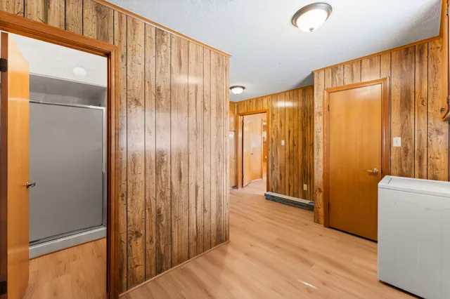 a view of a room with wooden floor and a window